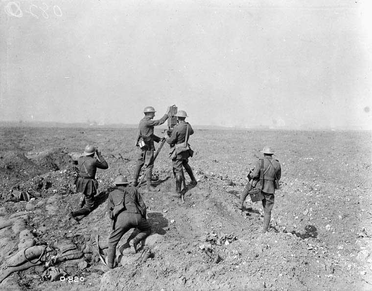 Canadian Official Photographer with artillery watching a battle on the Western Front, c. September 1916.