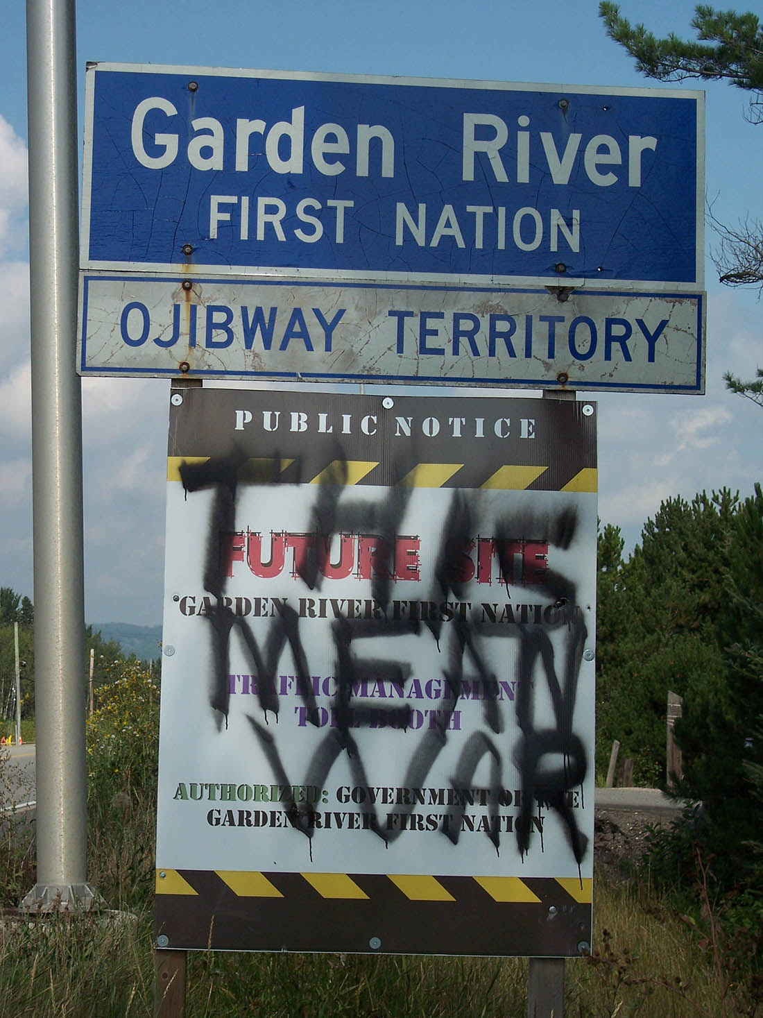 Vandalism on the front of the Toll Booth Public Notice Sign