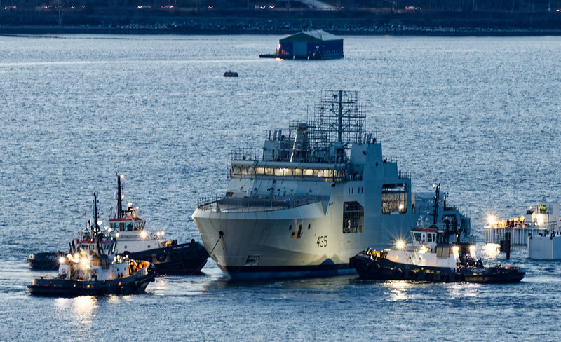 <p>HMCS <em>Robert Hampton Gray</em></p> Colour photo of naval vessel surrounded by tugboats.