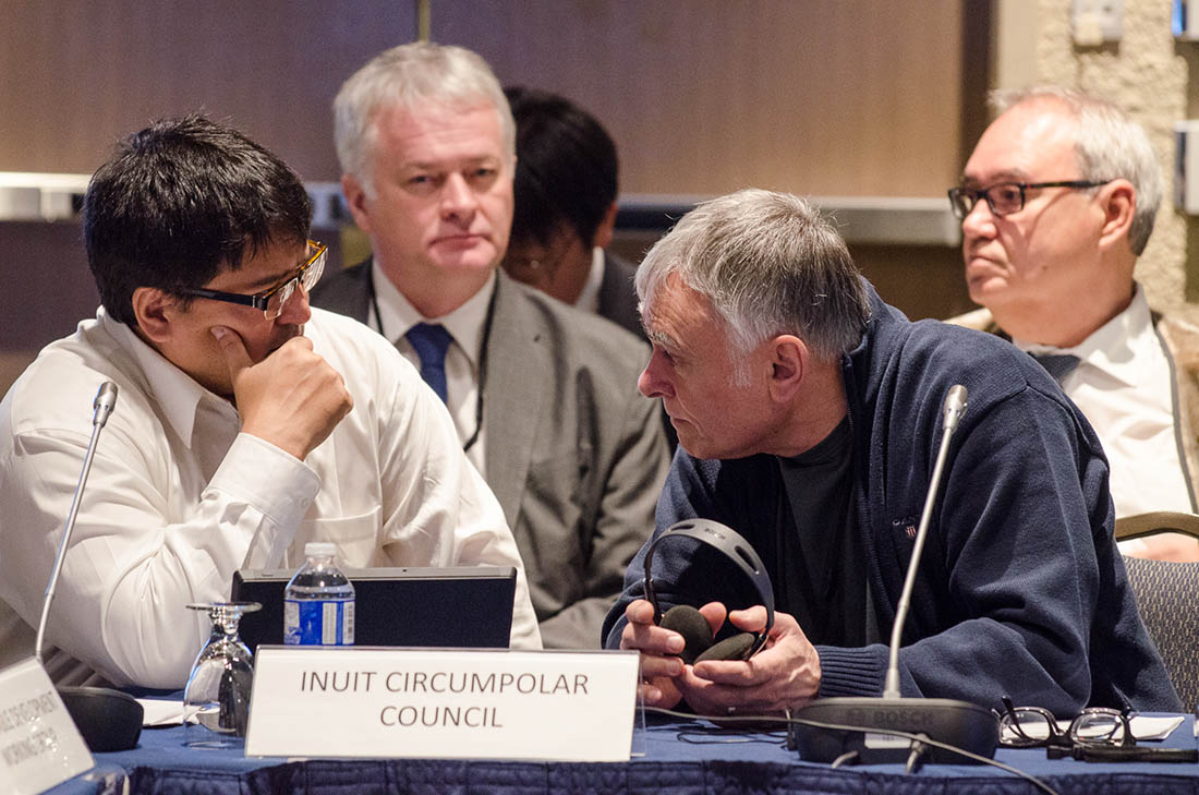 Two delegates sit behind a sign reading “Inuit Circumpolar Council”
