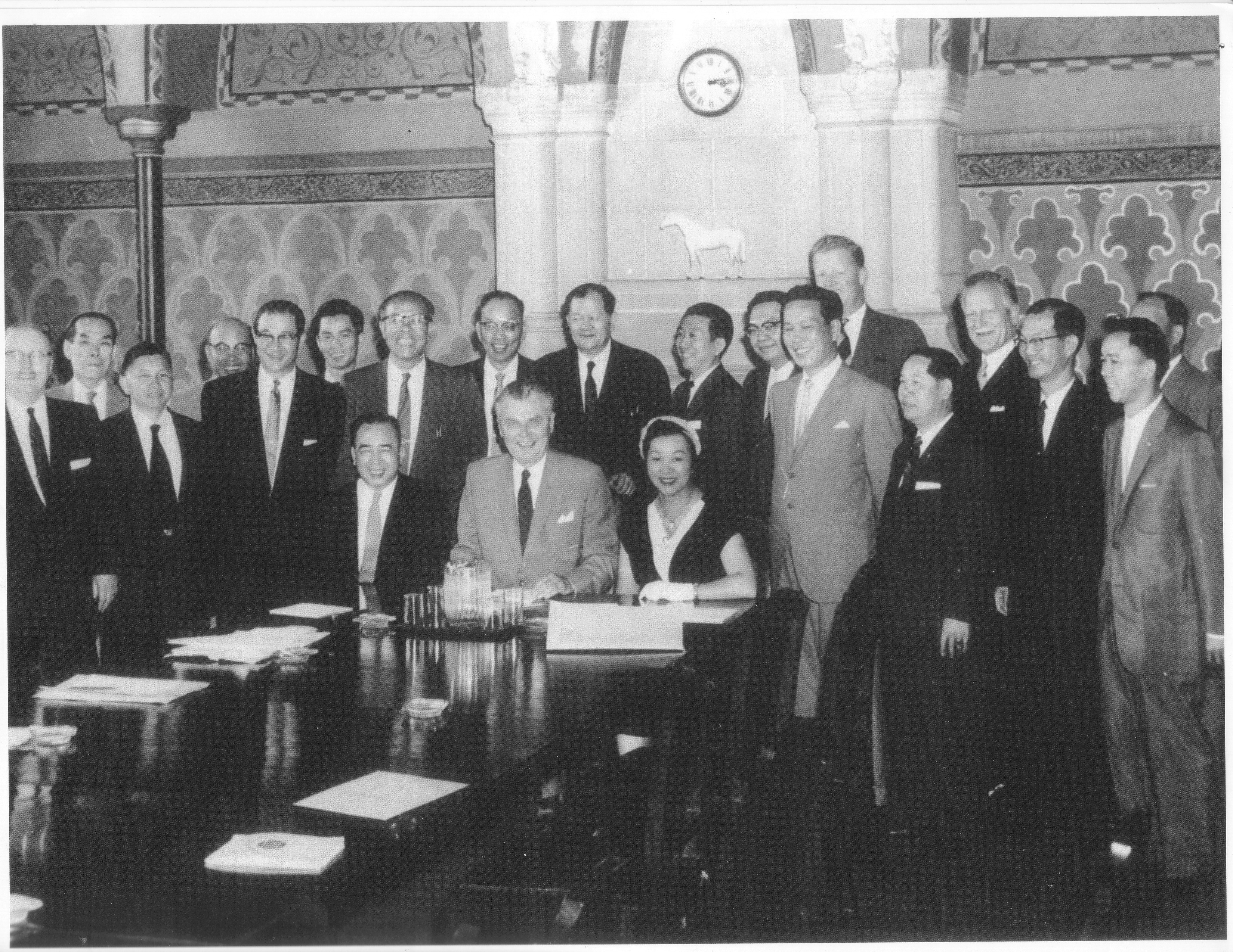 Jean Lumb with a Delegation to Ottawa and Prime Minister John Diefenbaker, 1957 A crowd of people besides a table.