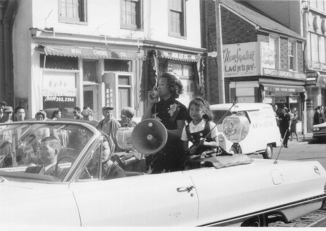 Jean Lumb, Chair of the Save Chinatown Committee Jean Lumb standing in a car with a megaphone.