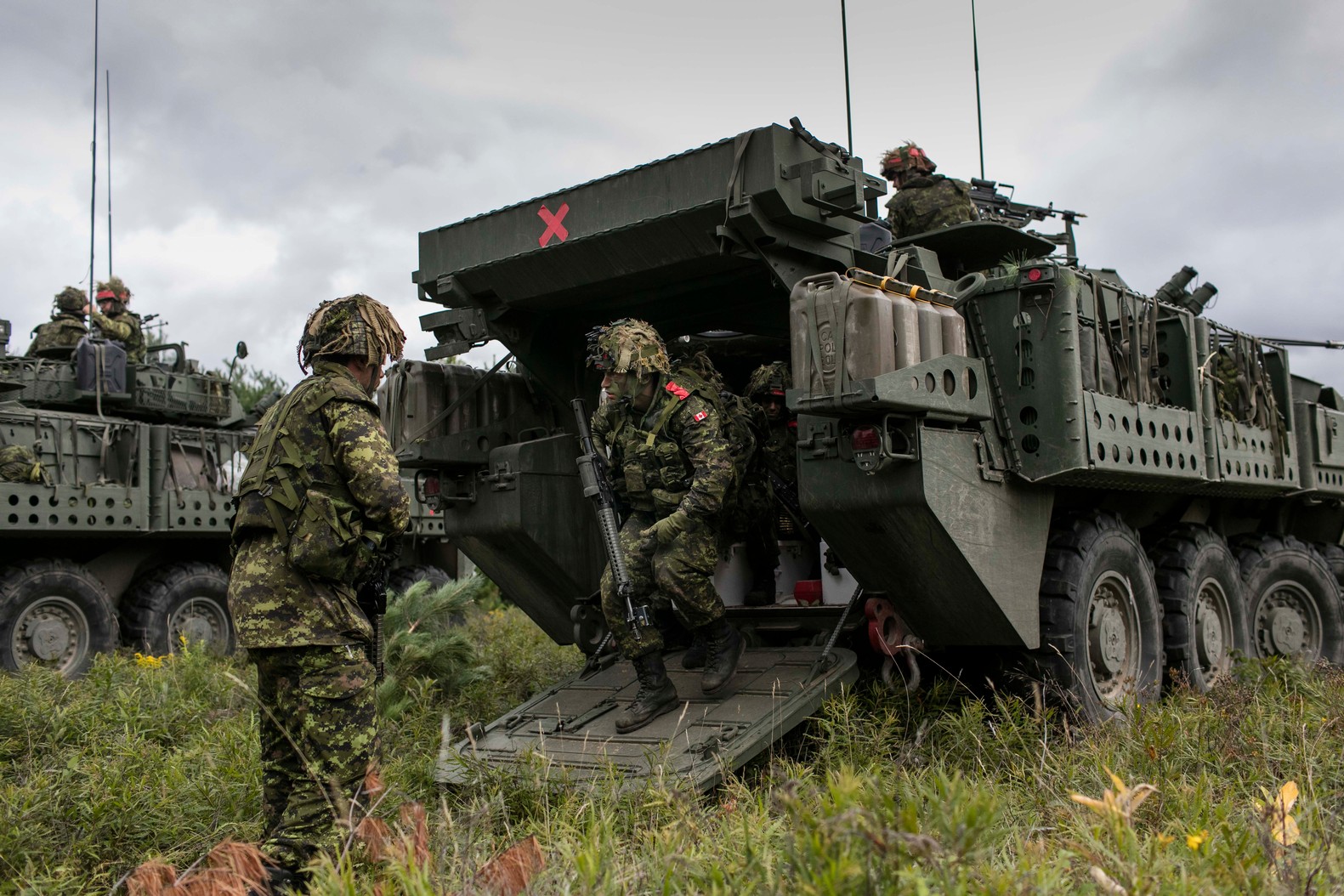 LAV III Soldiers getting off the rear of a LAV III. A second LAV can be seen behind.