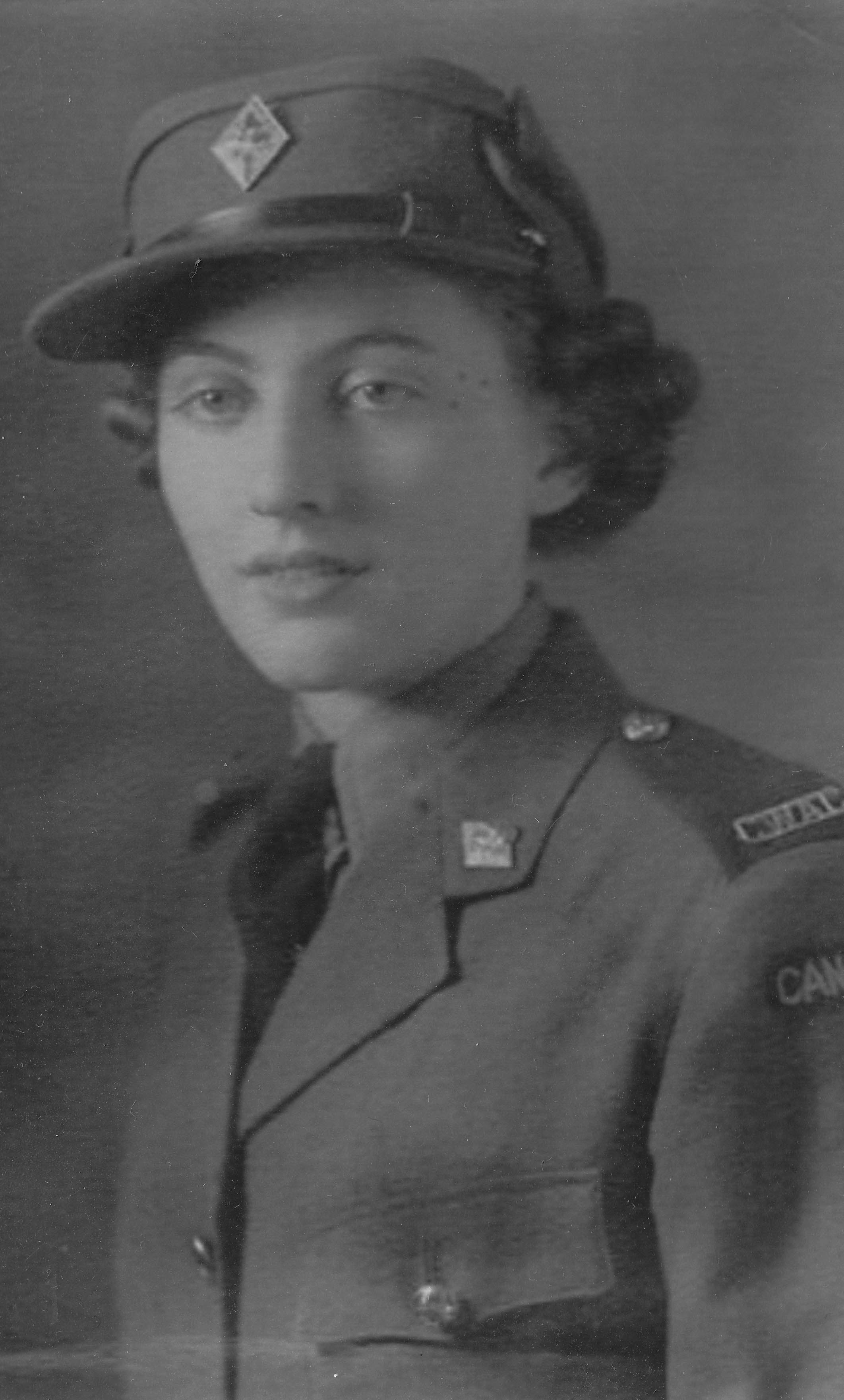 Black and white photograph of Olive Peat (nee Matthews), aged 19, in her army uniform in 1942.