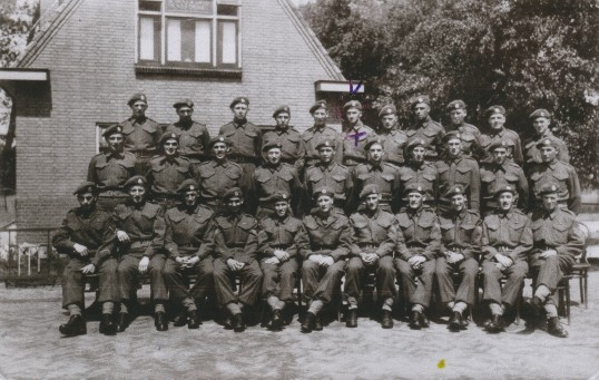 Rodolphe Blanchard (last row, sixth from right) stands with fellow comrades from The New Brunswick Rangers in Holland after the war, 1945.