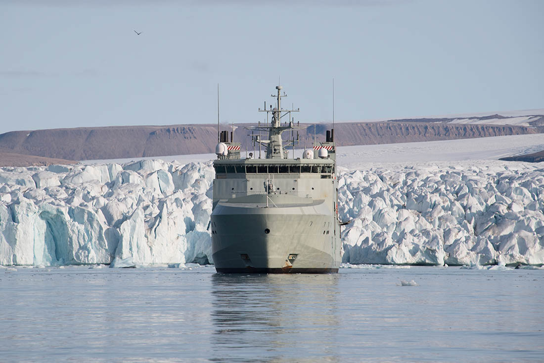 The HMCS Harry DeWolf floats in front of an ice field during Operation Nanook-Nunakput