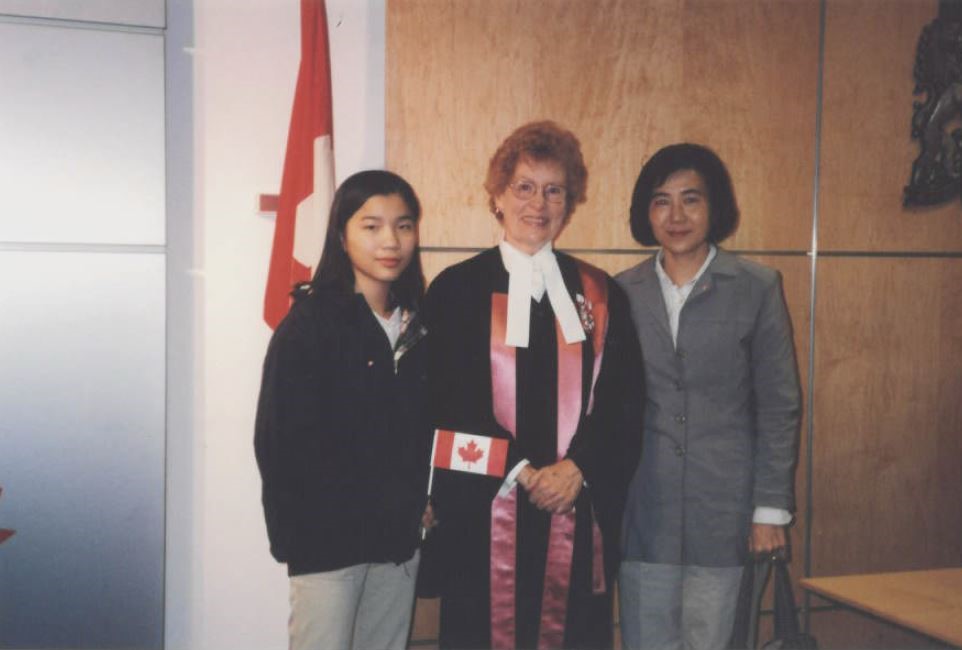 Taiwanese Canadians at a Citizenship Ceremony Two Taiwanese Canadian besides a Canadian citizenship judge