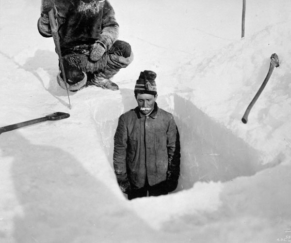 Digging hole to obtain thickness of ice, Fullerton [Harbour], Northwest Territories, Winter 1903–04