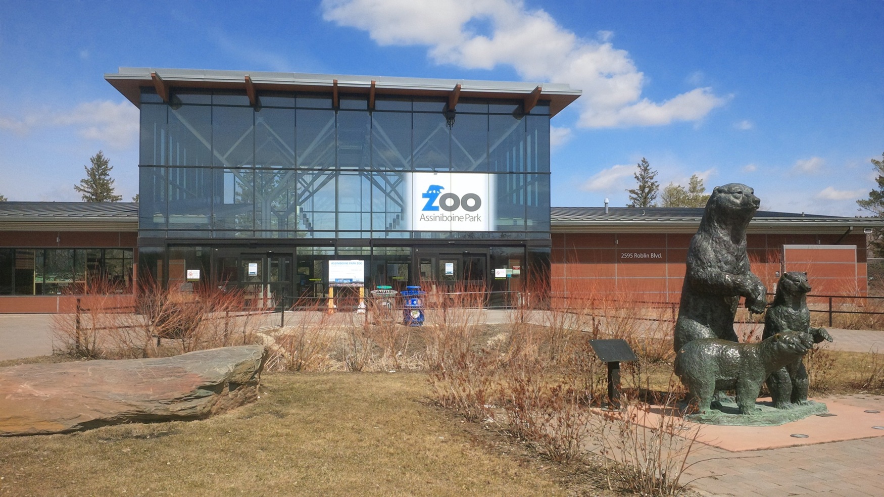 Glass building and entrance to the Assiniboine Park Zoo.