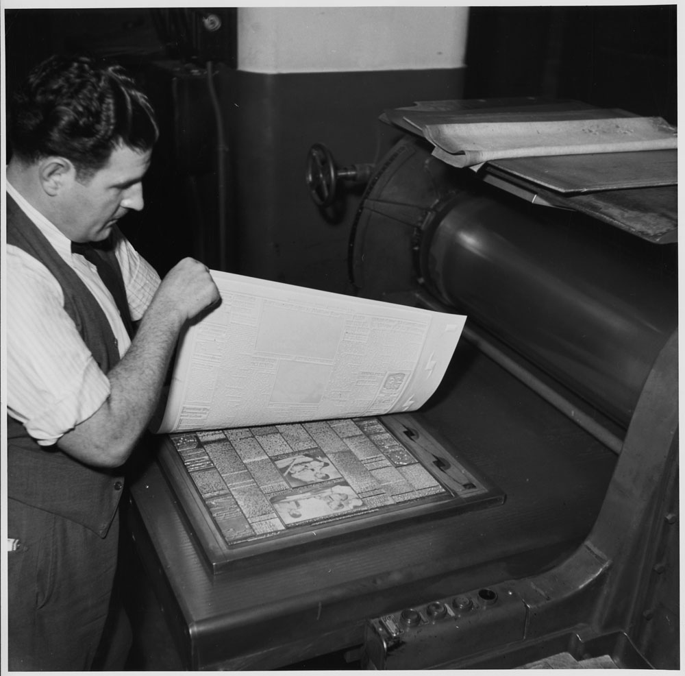 Globe and Mail Worker in the Newspaper Room Worker showing typeset plate in Toronto, Ontario, c. 1939-51.