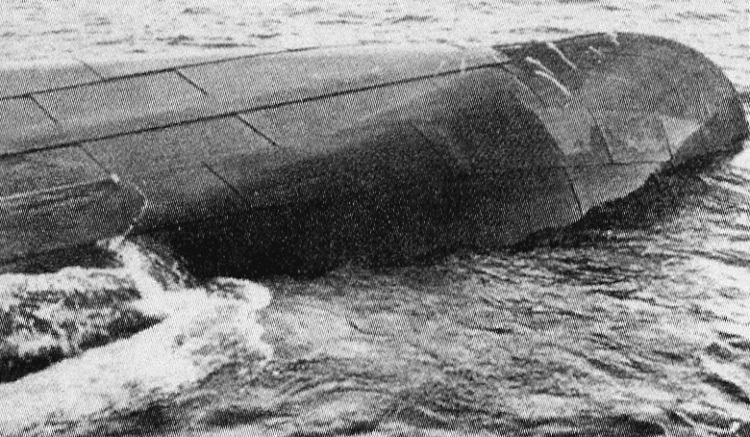 Ship upside down in water.
