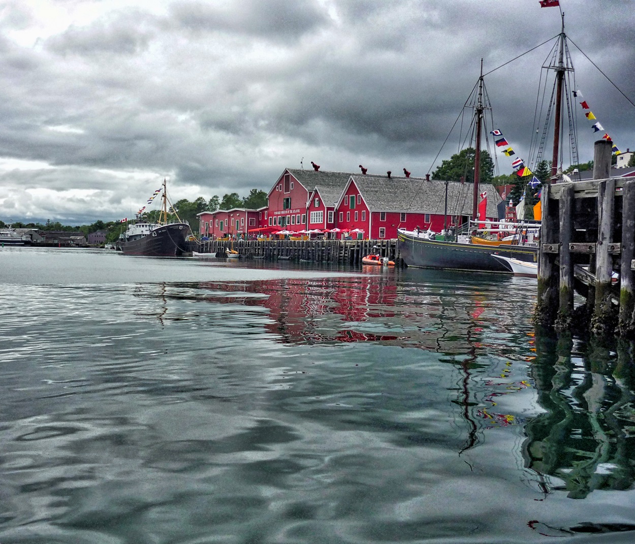 Lunenburg Waterfront Red building and wharf by the water.