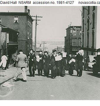 Sailors carrying spoils of the V-E Day Riot walking up or westerly along Salter Street between Hollis and Granville