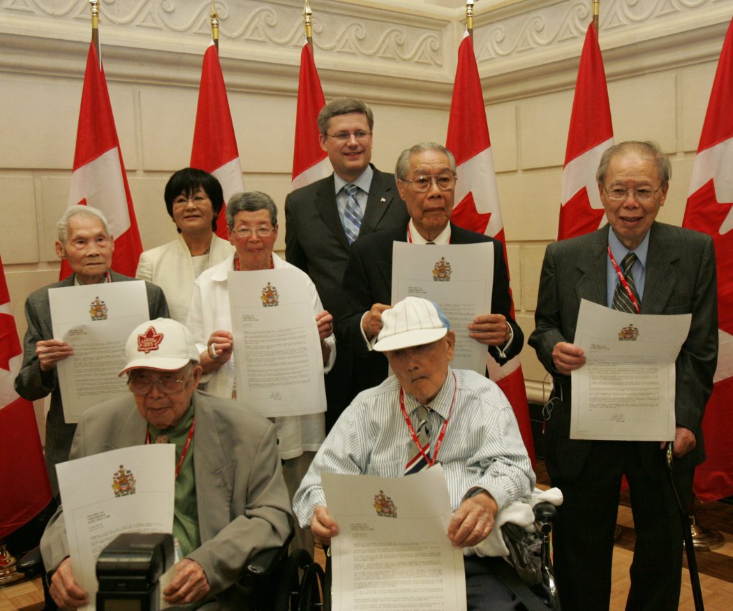 Chinese Head Tax Apology A group of elderly Chinese people with a Japanese woman and a white Canadian man behind.