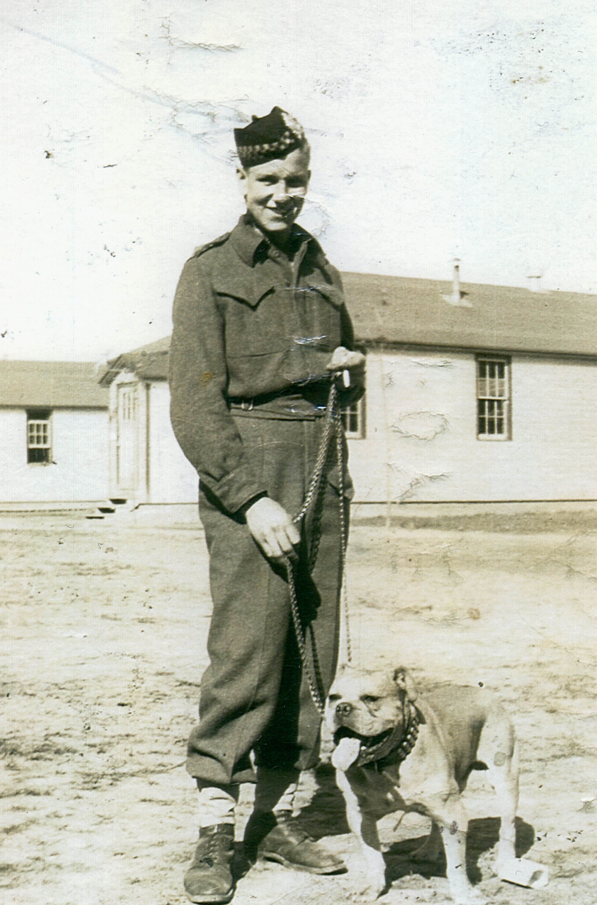 Private J. "Mike" Forester, age 16, with mascot dog, in Niagara-on-the-Lake, Ontario, 1940.